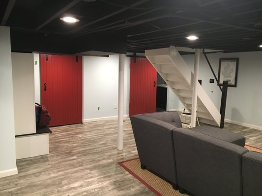 Update your basement with a black ceiling and red barn doors. Make a statement with paint!