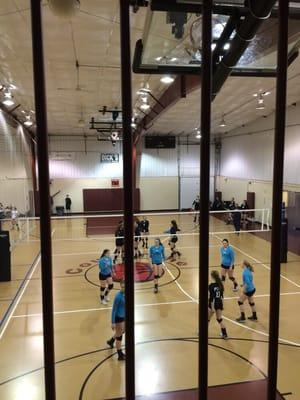 We are at Volleyball Tournament in Pittsburg, but were arrested after entering the gym, thus the bars in the picture