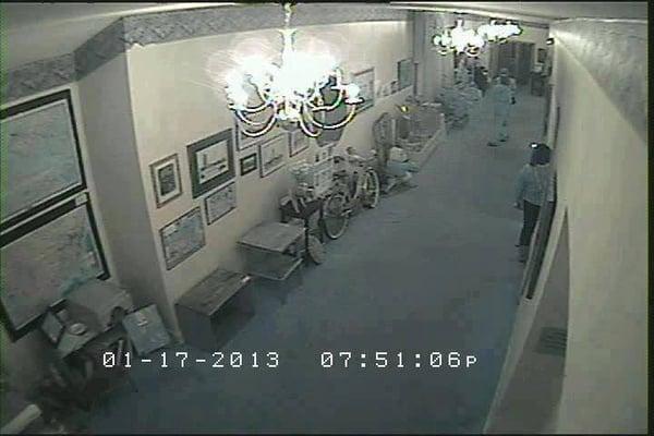 Security Camera only shows 3 people in the hallway.