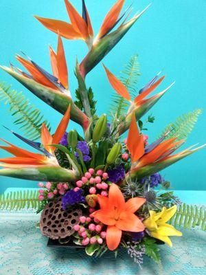 Happy  tropical arrangement featuring Birds of Paradise with a burst of color to brighten your day.