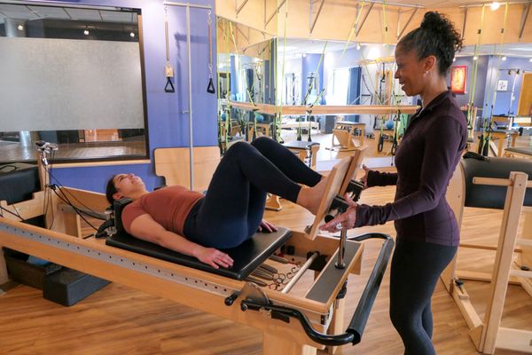 Stephanie working with a client on the reformer