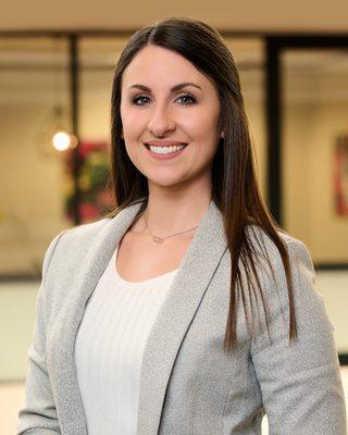 Corporate headshot of a financial services manager in her offices