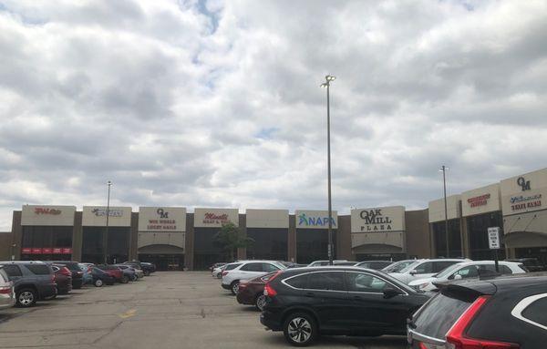 Strip mall storefront at Oak Mill Mall. It's second from leftmost.