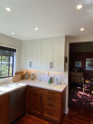 Beautiful white cabinets with quartzite counters and cherry drawers