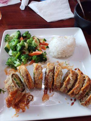 Rollo Villarreal with a side of vegetables and white rice.