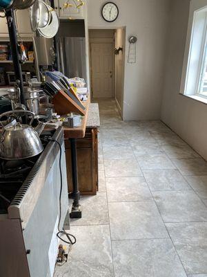 Tile floor installation in kitchen