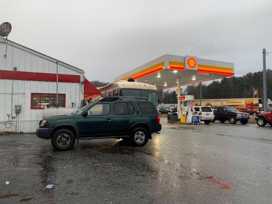 Parking area adjacent to the entrance and gas pumps