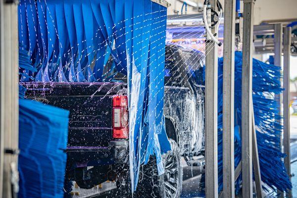 Automated car wash tunnel provides pre rinse through to premium protectant products followed by a dry blowers