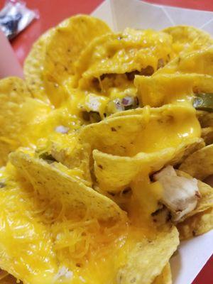 Chicken and cheese nachos with onions and jalapenos