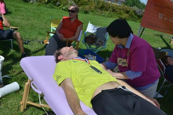 Dori Taylor, RN, practice member volunteers for post race massages, here on a local doctor at the Advantage Chiropractic tent.