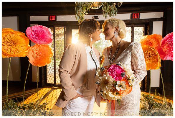 Jumbo paper flower decor, and matching bridal bouquet of handmade paper flowers.