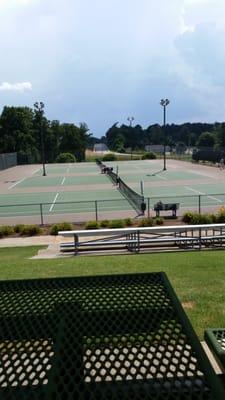 A shaded seating area that overlooks one of the courts.