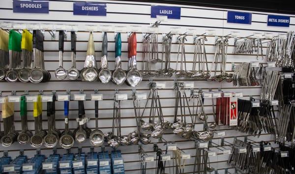 Huge display of round bowl dishers, serving ladles, and other smallwares at Fein Brothers.