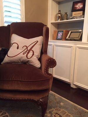 New upholstery and a embroidered pillow instantly make the room feel like home