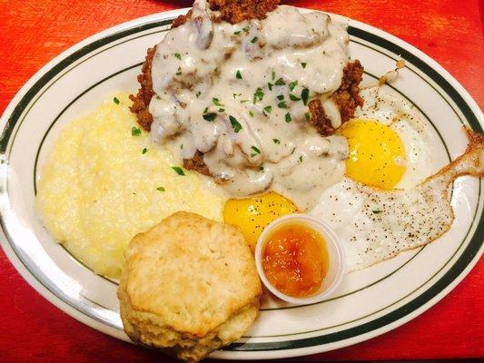 Chicken style steak with biscuit and eggs.