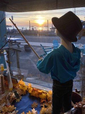 Looking out the shop window at the seaside sunset