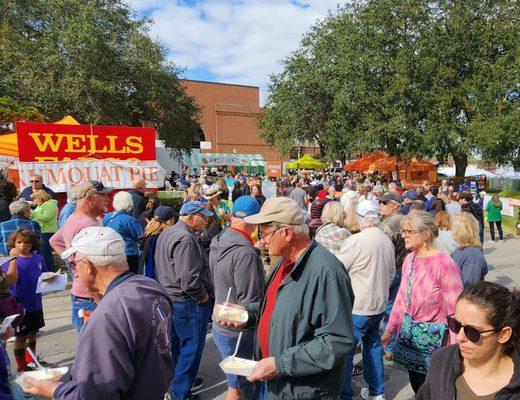 Thousands of people at the Kumquat Festival enjoying Kumquats,  Kumquat pie, Kumquat ice cream, Kumquat beer and other Kumquat products.