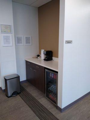 Snack area with mini fridge & coffee.