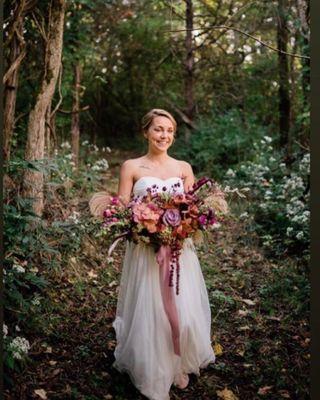 Beautiful bride walking down one of trails At Hilltop Farm Venue.