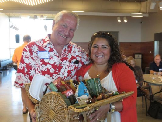 Agent Jennifer Torres presenting a gift basket donated by Neptune Properties.