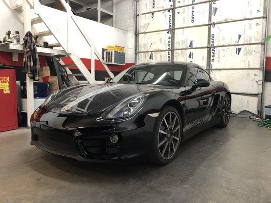 2014 Porsche Cayman in for brakes, oil change, exhaust install, and bumper replacement.