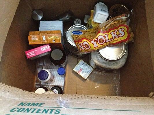 Glass kitchen jars and food was just tossed into a box.