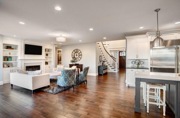 Open concept cozy living room with elegant white kitchen.