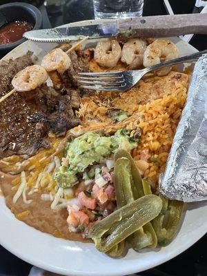 The El Trio that I ordered. It's skirt steak, chicken breast, 6 shrimp skewers beans, rice, pico de gio, guacamole, and pickled jalapeños