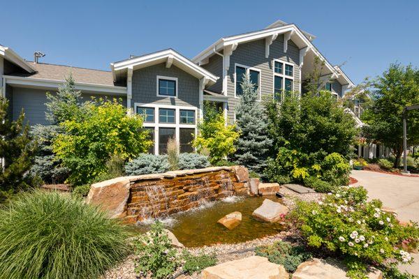 Small water fountain pond at the entrance of the exterior at The Trails at Timberline