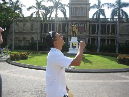 Searching for clues at the King Kamehameha statue in Downtown Honolulu