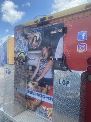 Back of the food truck with pic of main cook.