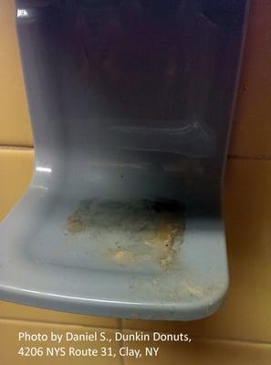 Men's room soap dispenser with dried  soap residue indicative that employees do not clean their hands after using facilities...