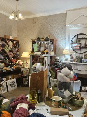 The interior of the yarn store. Yarns line the walls and tables.