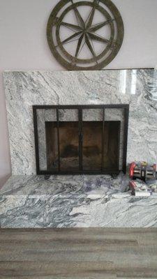 Granite covering a brick fireplace done by Granite Interiors