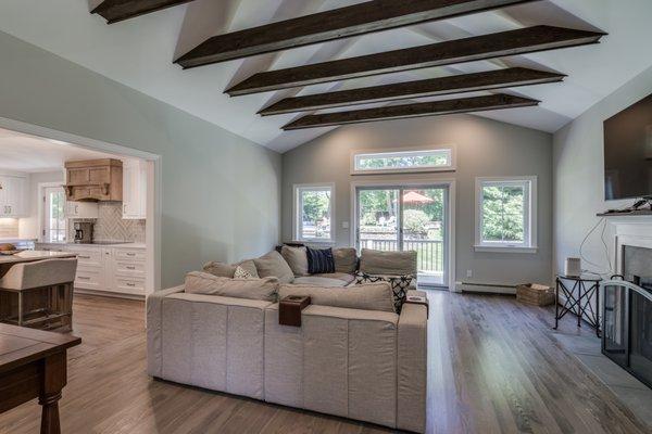 Furnished custom living room with beautiful, big, bold ceiling support beams.