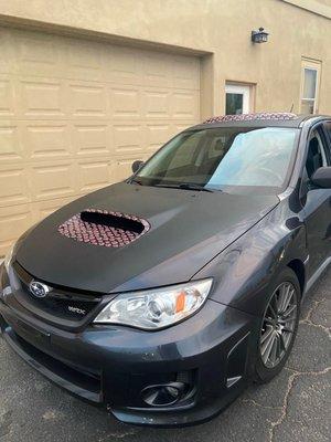 Carbon fiber wrap with custom print accents on this WRX