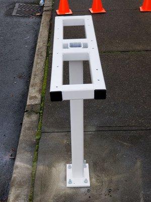 AGA manufactured this mailbox base out of steel and mounted it to the sidewalk with three new mailboxes for the tenants.