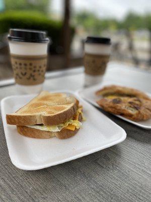 Sausage egg and cheese sandwiches with coffee