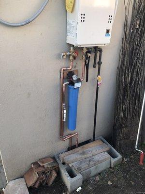 Tankless water heater install with filter and gas sediment drip leg. T&P line is being ran will post more pictures.