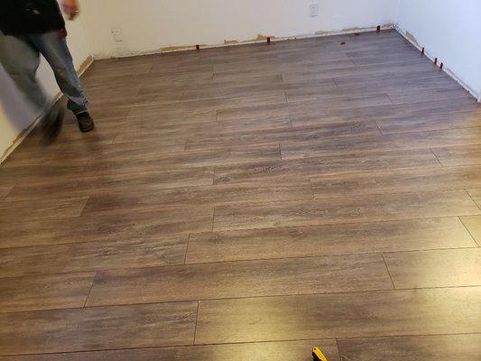 Installing laminate flooring for a satisfied customer