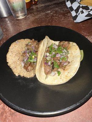 Carne asada tacos, handmade tortilla on left