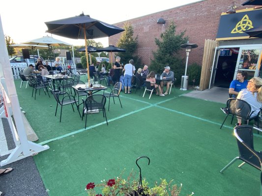 Outdoor patio seating with live music on a Friday evening.