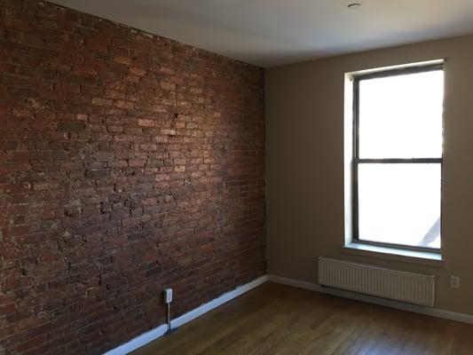 Beautiful Exposed Brick in our Two Bedroom Unit near 132nd Street