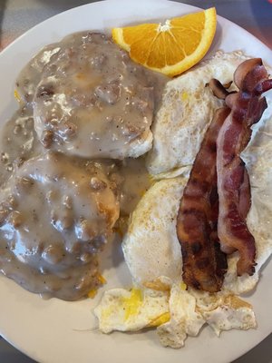 Sausage gravy over cheese biscuits, eggs and bacon.