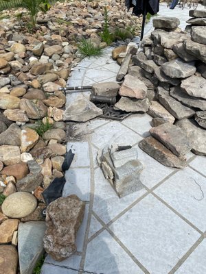 Unfinished waterfall with broken rocks left all over pool deck. Created leak in pool.