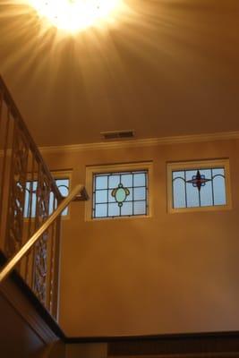 A view of the pretty stained glass windows at the top of the stairs.