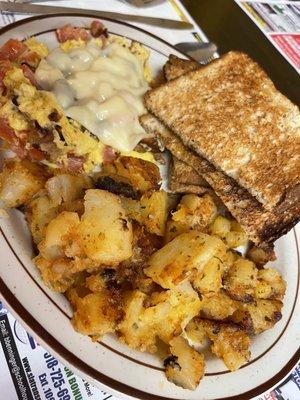 Tomatoes, bacon, onion & provolone egg scramble with some perfectly cooked home fries.