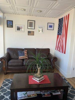 Comfortable waiting area with complementary coffee and water