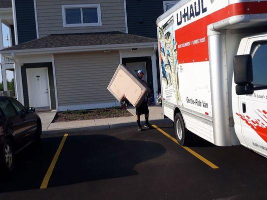 One of our hard workers carrying a pillow to be loaded