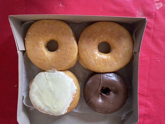 Two glazed, lemon filled and chocolate with chocolate icing.